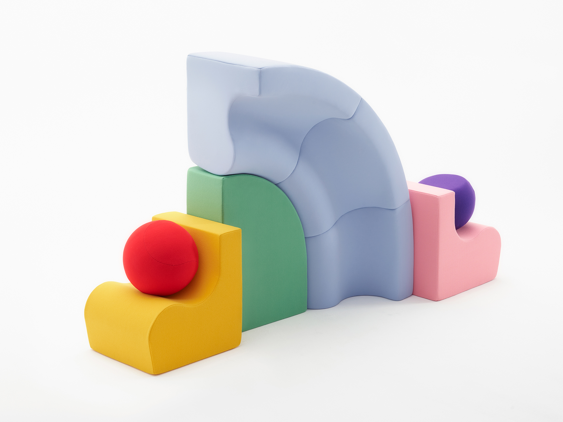 Colorful family modular furniture stacked into a playful sculptural arrangement.