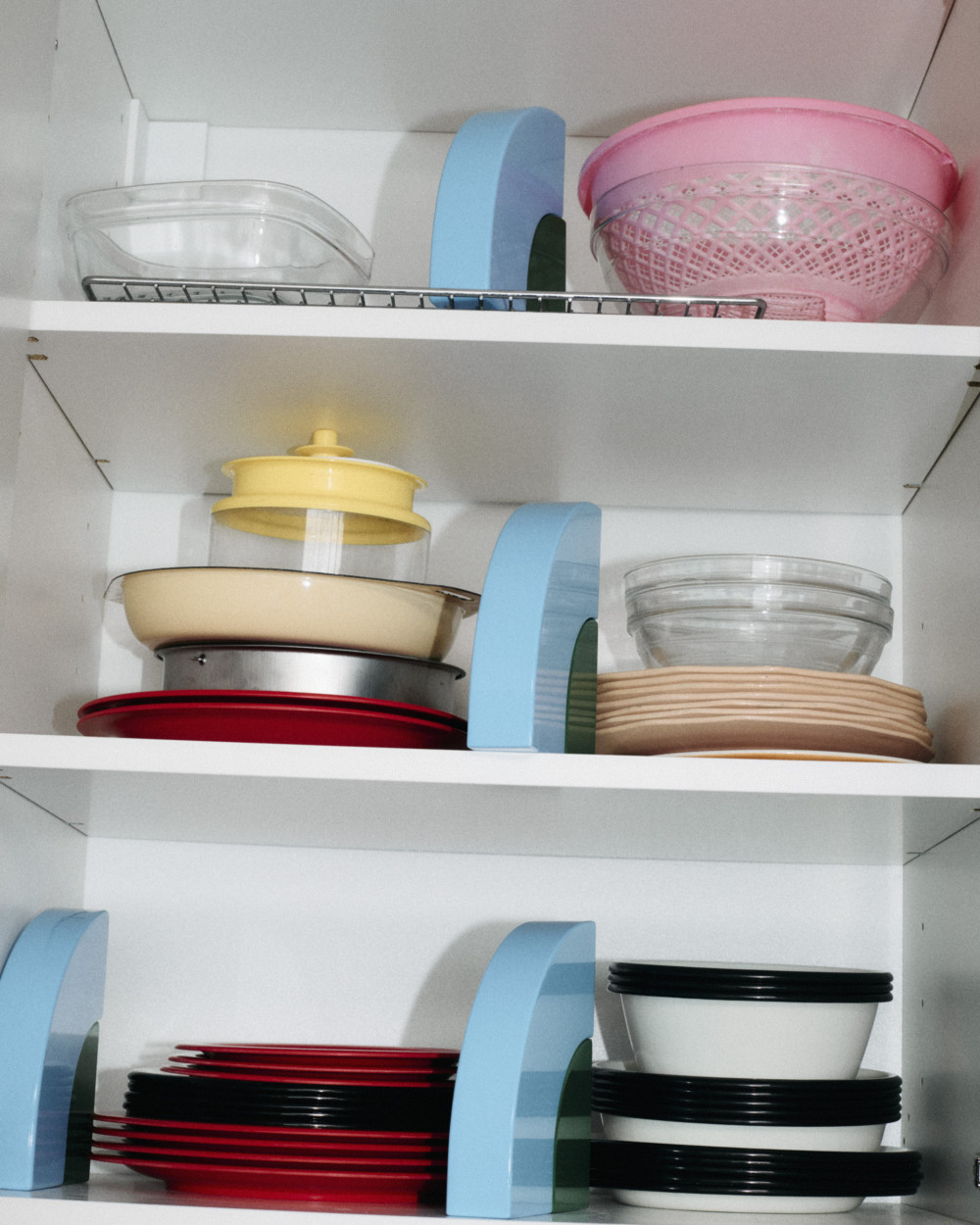 A grouping of Little Family elements by nara.world used as shelf dividers organizing kitchenware