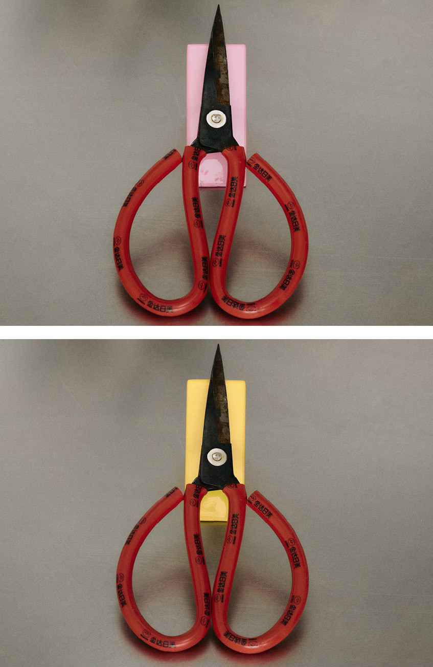 Scissors placed on top of colorful modular blocks from the Little Family collection by nara.world, demonstrating their use as functional stands